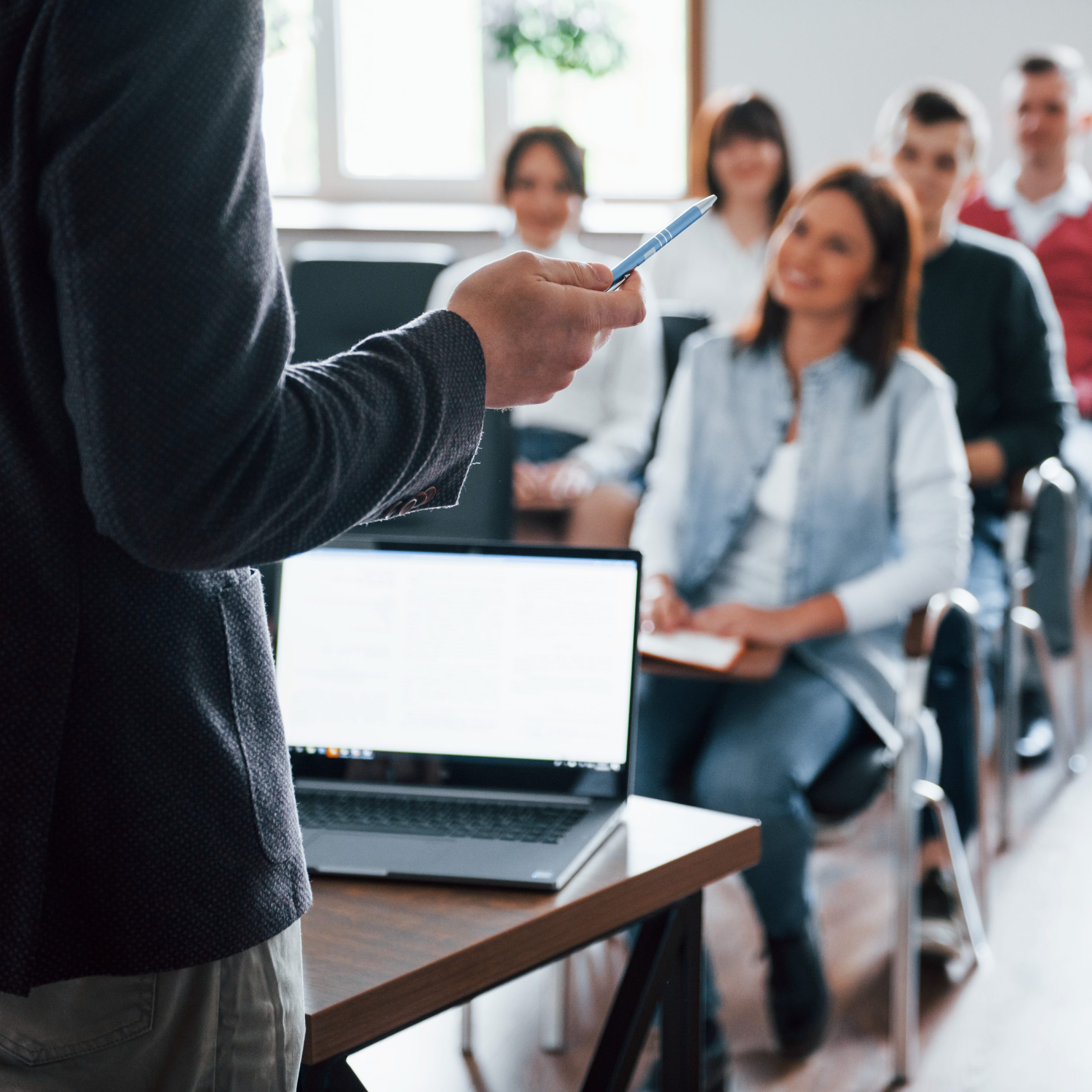 everyone is smiling listens group people business conference modern classroom daytime scaled